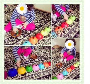 Sorting _toy_ pieces _by_ color_ using_ jumbo_ tweezers